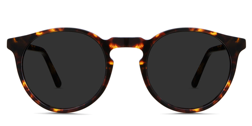 Seraph black tinted Standard Solid sunglasses in Delaney variant - it's a rounded acetate frame in tortoise pattern and have a high keyhole nose bridge.